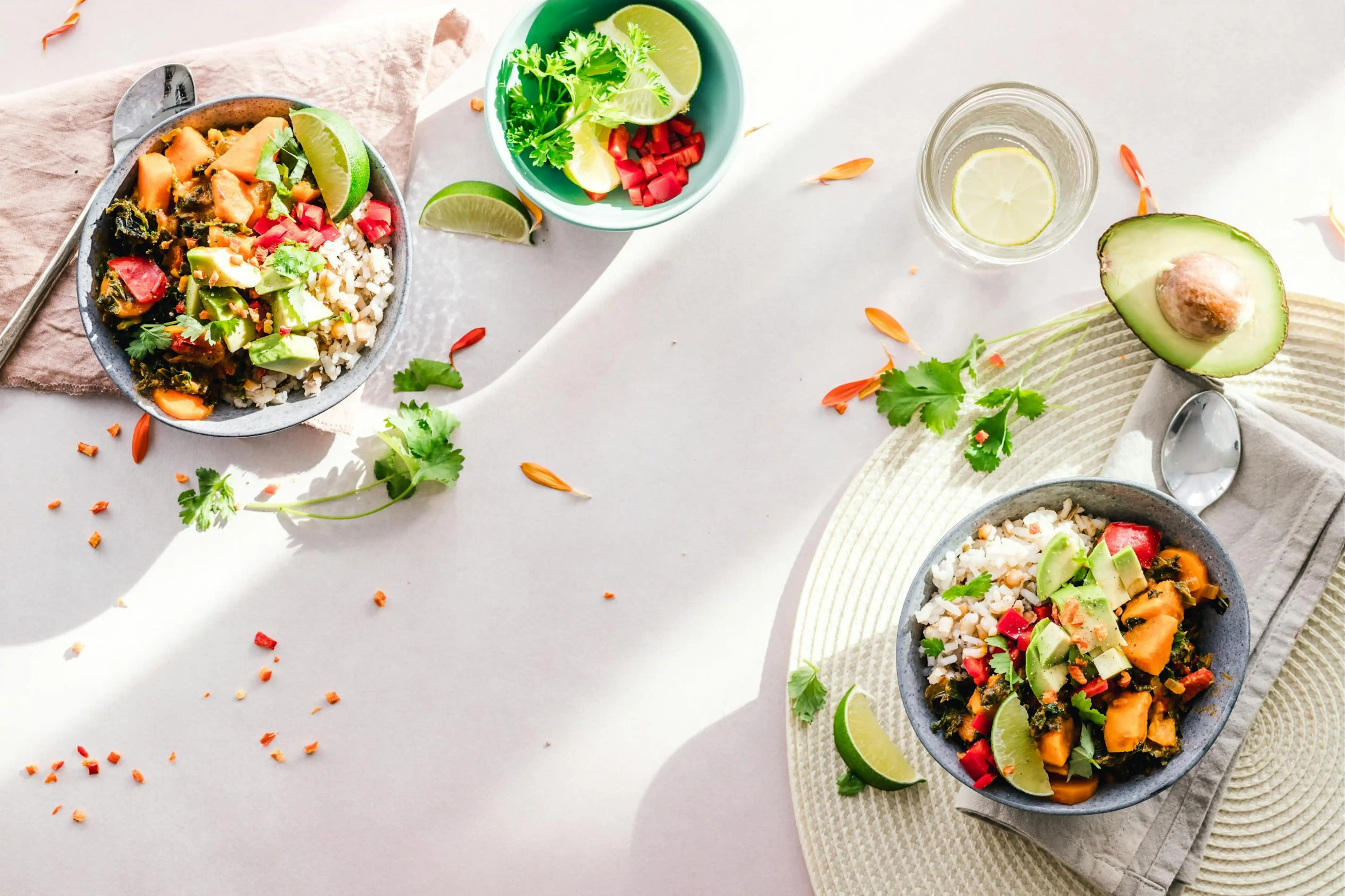 Two colorful bowls of healthy vegetable salad with toppings.
