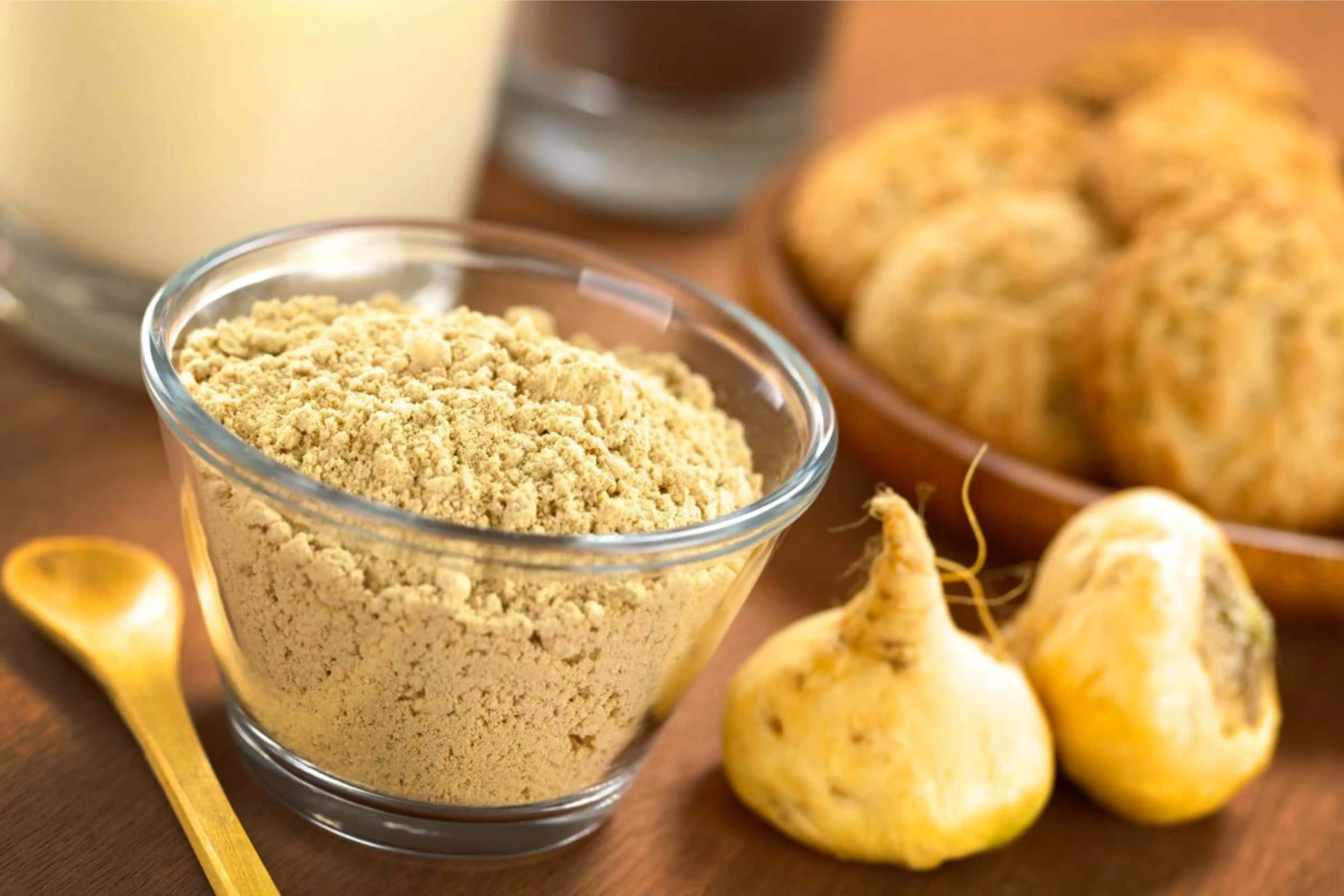 Maca root and powder on rustic background.