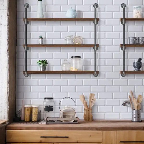 Industrial pipe shelf with wooden boards and decorations.