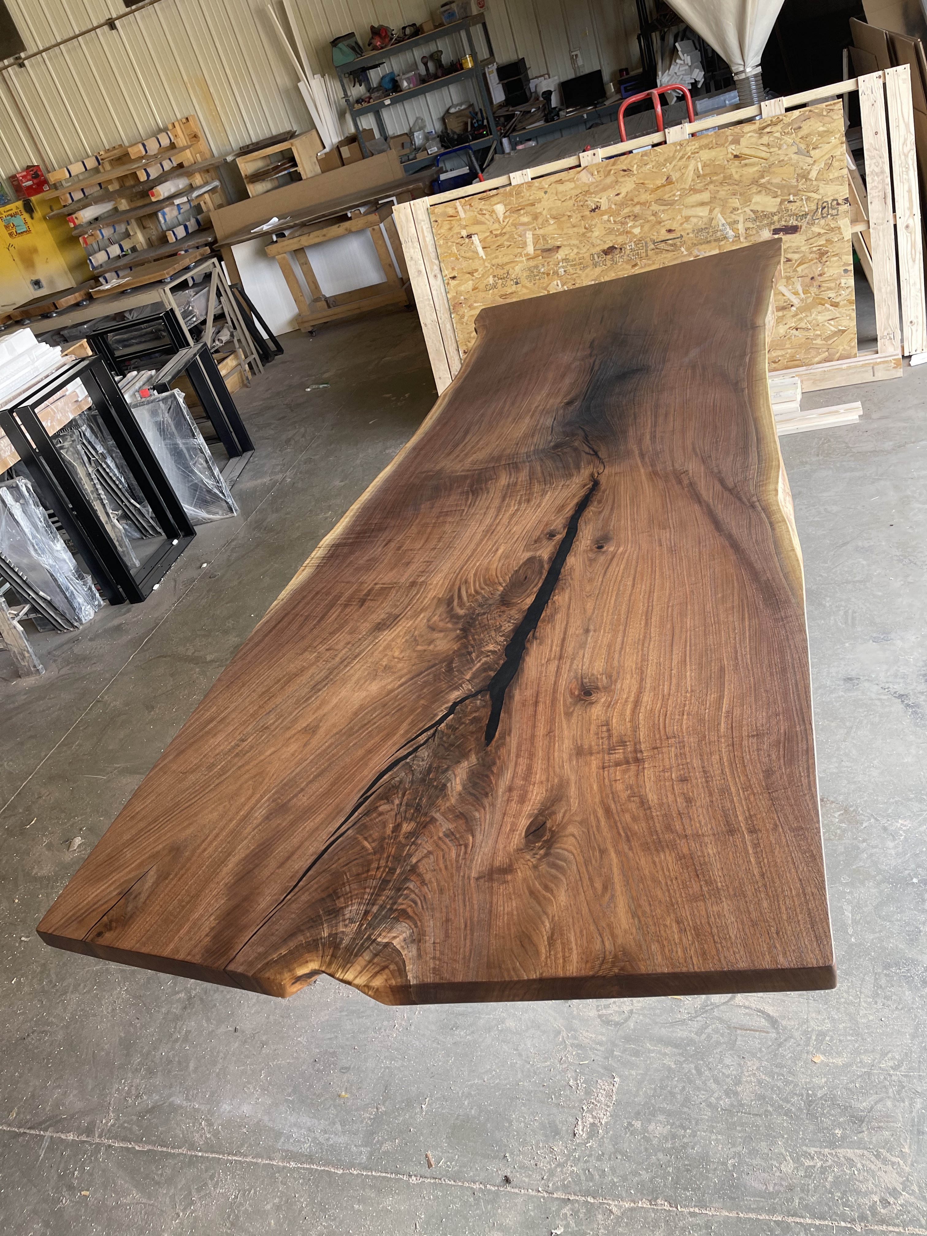 A large, polished wooden slab with a natural edge.