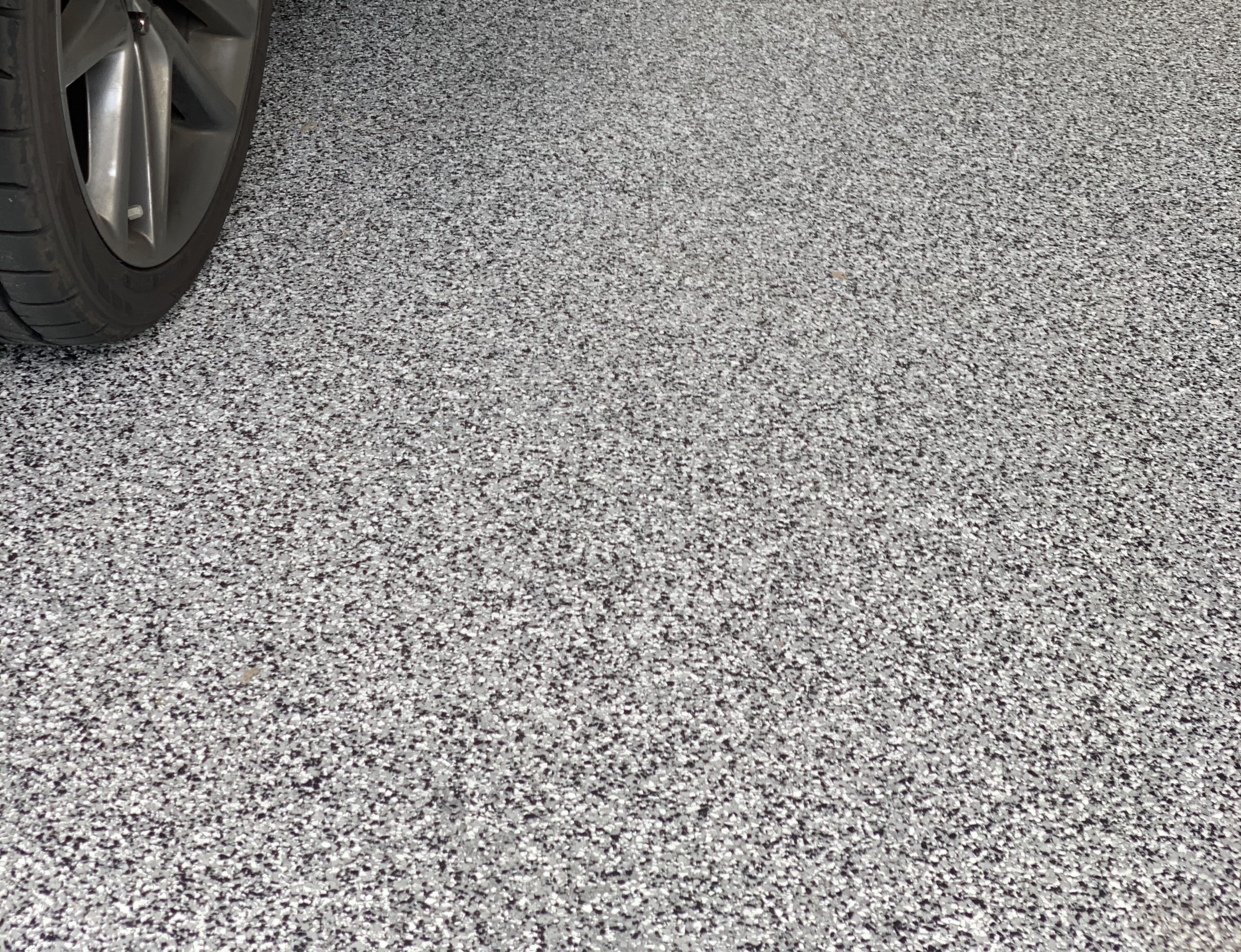 Beautifully coated concrete patio with plants and seating.