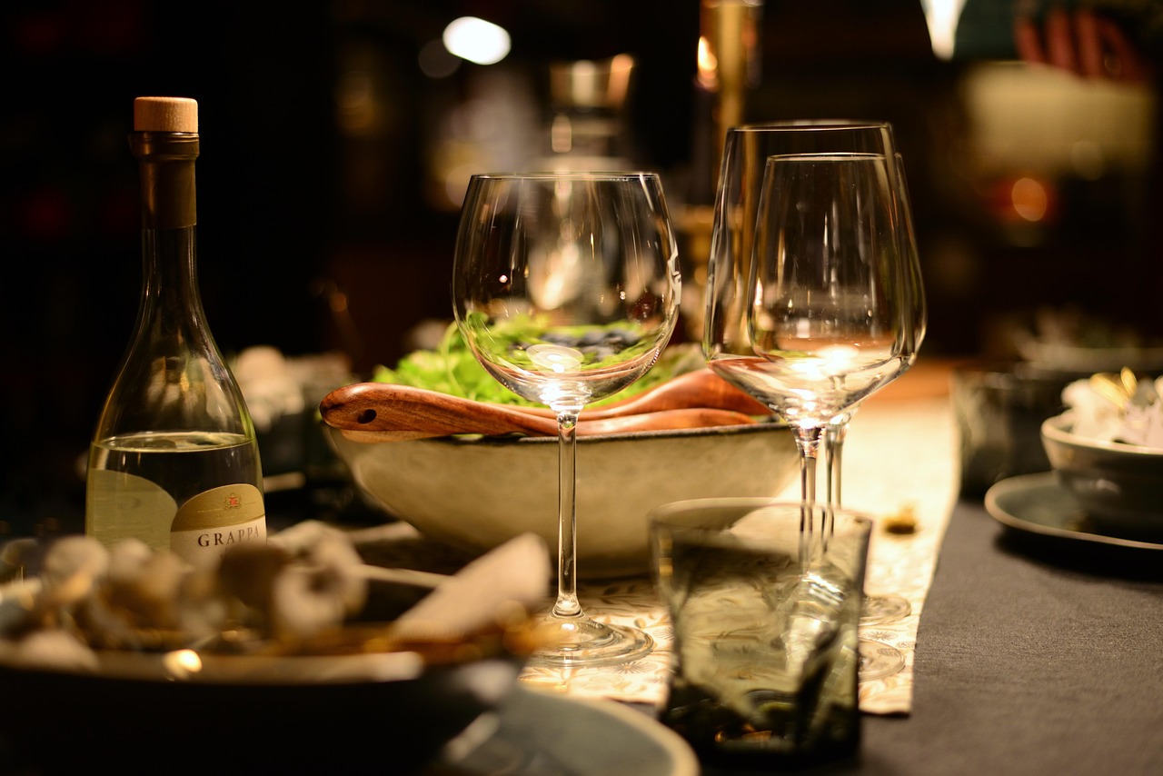 Elegant dinner table with wine glasses and bottle.