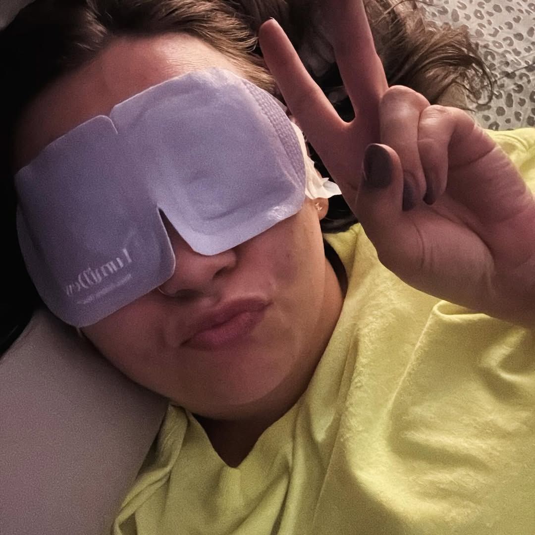 Person relaxing with a warm disposable eye mask.