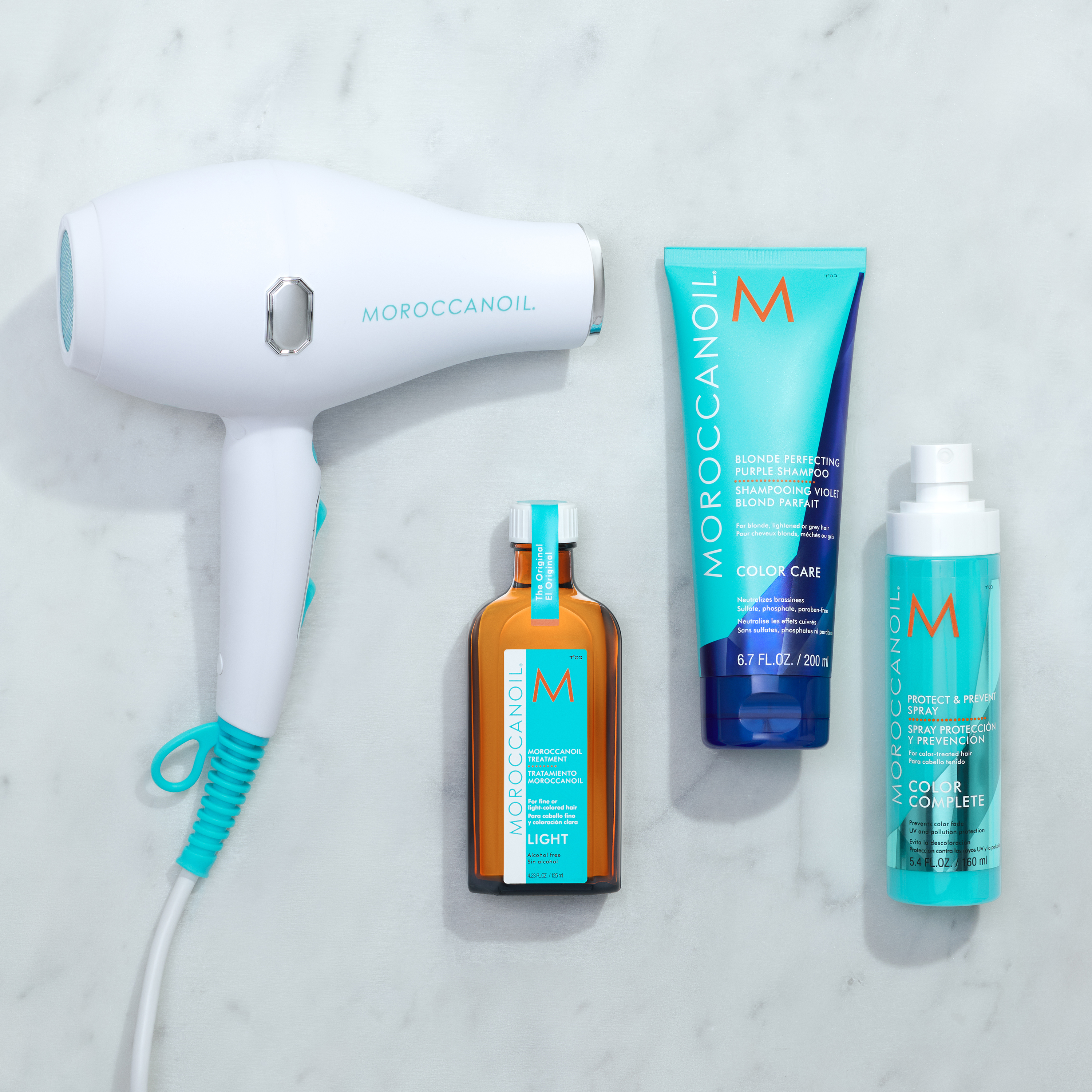 Hair styling tools beside Moroccanoil hair products