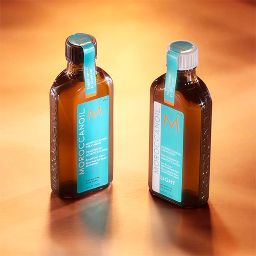 Two bottles of hair treatment on wood