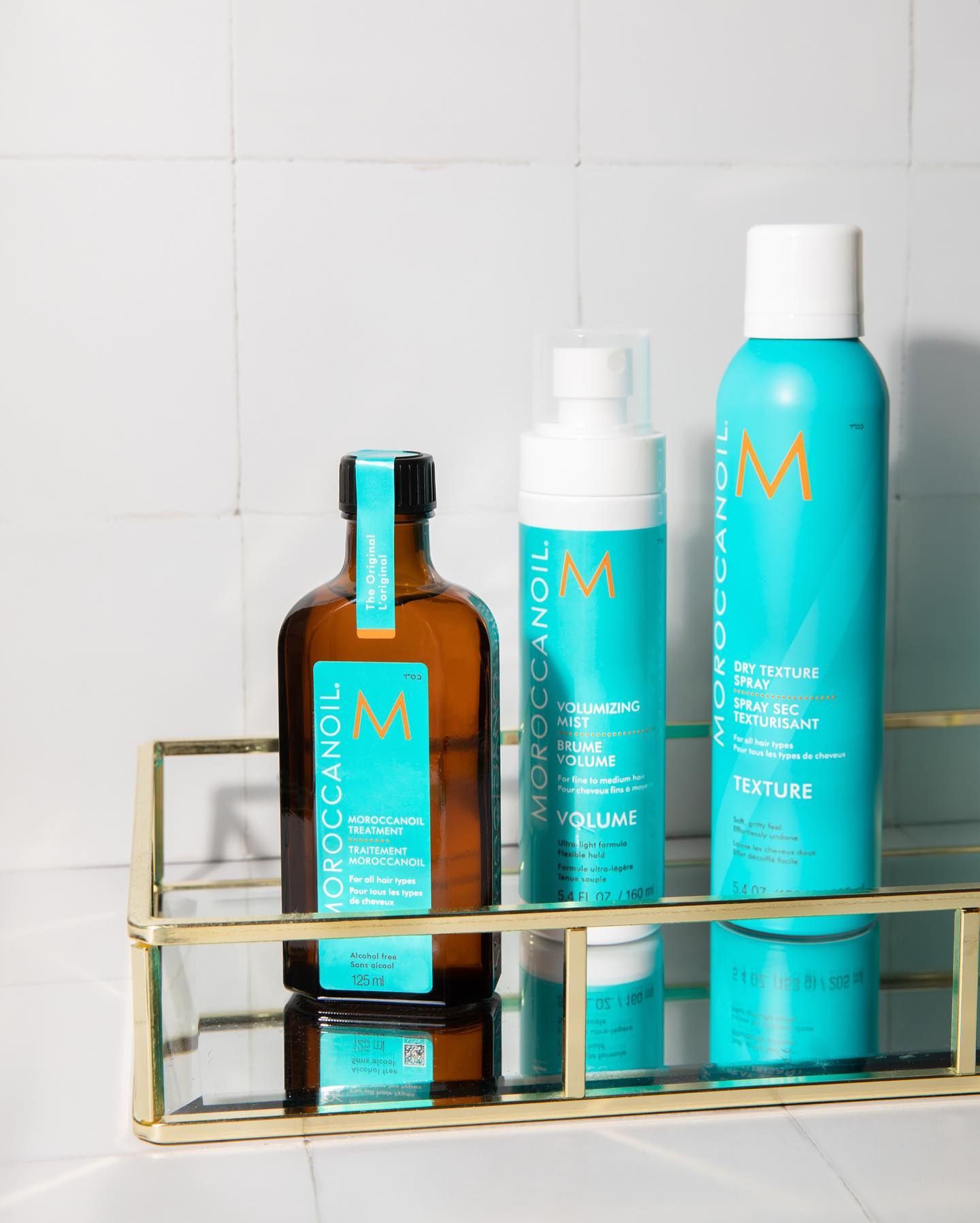 Moroccanoil hair treatment bottle surrounded by turquoise boxes